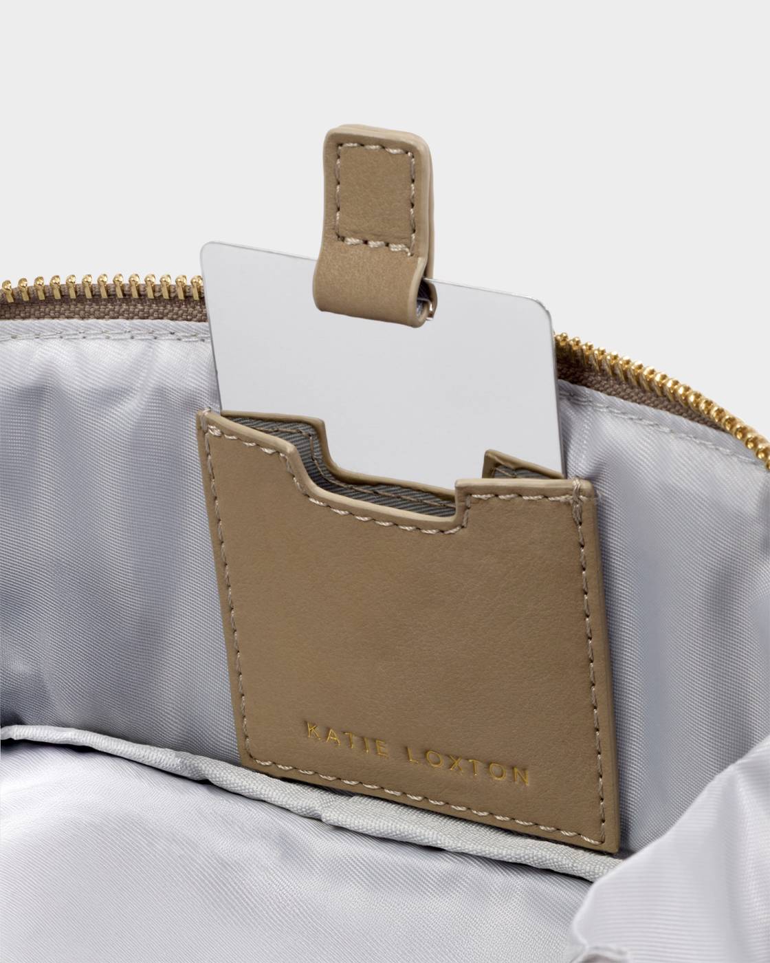 Close-up of a beige cardholder attached to a gray bag with 'Ninety Percent' branding.